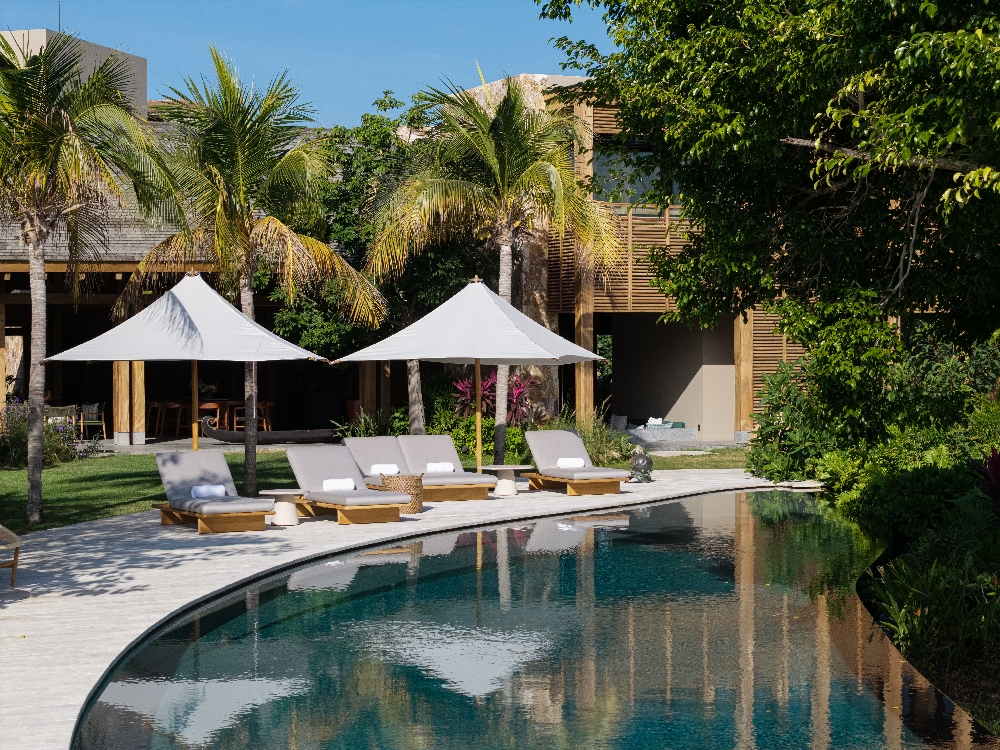 Exterior view of the private swimming pool at Villa Ipanema overlooking the golf course in Punta Mita, perfect for luxury family vacations.